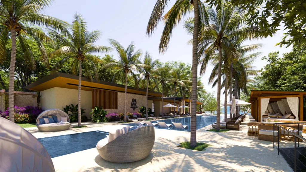 La terraza de piscina del Ocean Club en Cantomar, a la sombra de palmeras y caba&ntilde;as